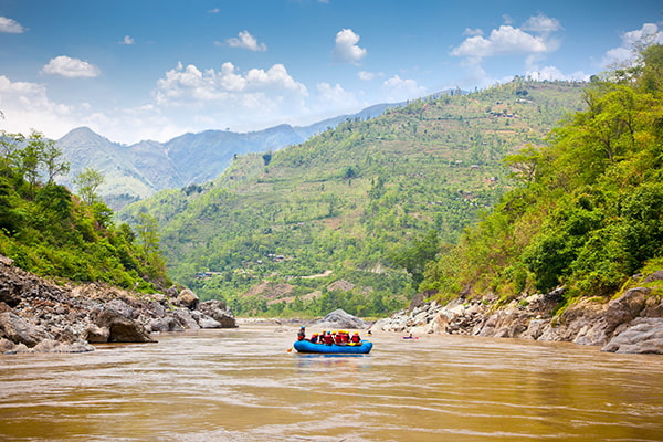 Group of white water rafters cheering and happily posing