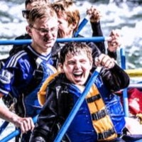 Happy white water rafter smiling on a turbulent river